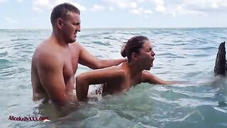 A couple makes love directly in the water of a stunning blue lagoon