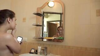 A mature woman with big tits masturbates early in the morning