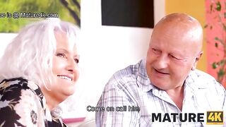 A guy is having fun with a mature woman while her husband watches