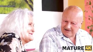 A guy is having fun with a mature woman while her husband watches