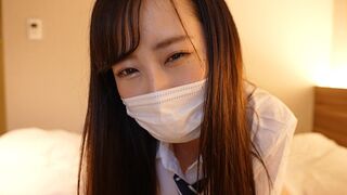 A Japanese girl in a sailor suit masturbates her friend’s cock with her hand
