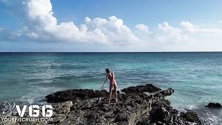 A hot girl is naked on the beach, enjoying a solo moment