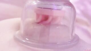 A girl masturbates with a toy and sucks her nipples