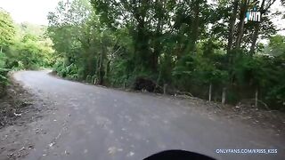 A girl has her first ride on a motorbike with a stranger in the jungle