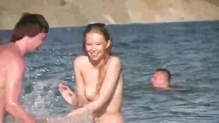 A mature woman is having fun naked on the beach