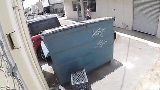 A girl is fucking behind the garbage tank, unaware of being watched