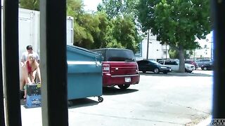 A girl is fucking behind the garbage tank, unaware of being watched