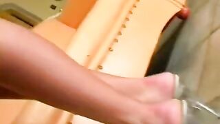 A cute woman masturbates her sweet pussy in a leather chair