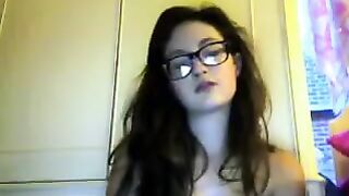 A cute student with glasses plays with her body on a video chat