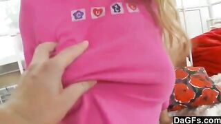 A sweet young blonde plays with a toy on the bed in this steamy scene