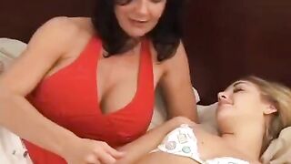 A young woman is having fun with her MILF girlfriend using a strap-on