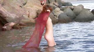 Nudist girl has small boobs and gets wet in the rain