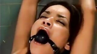 Girl was tied up and fucked by a bald man on a machine