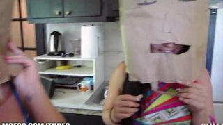Girls wear on their heads bags with holes for mouth and sex