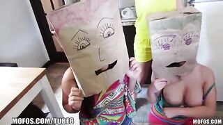 Girls wear on their heads bags with holes for mouth and sex