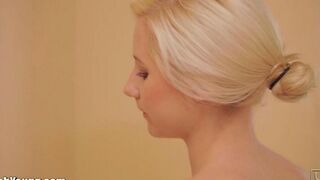 Girl plays with herself with a toothbrush as a handle in the bathroom