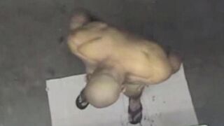 A naked man in the shower, spied on by a camera