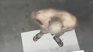 A naked man in the shower, spied on by a camera