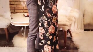 The red-haired beauty in a long black dress is fucking passionately