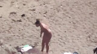 A pair of naked people enjoy each other in the sea