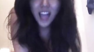 An Asian girl masturbates herself on the bed with intense pleasure