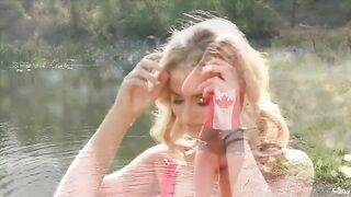 A blondie caresses herself tenderly by the lake in 4K