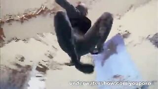 A hot girl is floating naked in the swimming pool