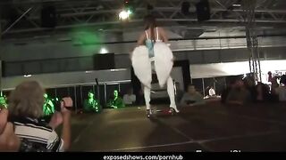 A hot brunette learns the art of striptease on a pole with passion
