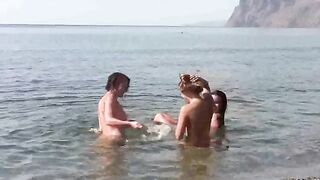 A naked girl is having fun on the beach