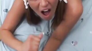 A blond girl with glasses stands on all fours to be fucked doggy style