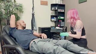 A tattooed woman is having fun with a black guy in an intense scene