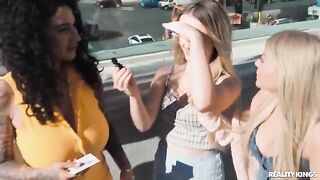 A pair of sexy girls are having fun on the strip, and another girl joins them