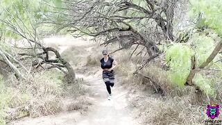 A girl with big boobs is doing a workout on the trail