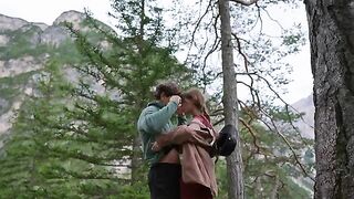 A couple making love outdoors, caught up in the raw intimacy of nature