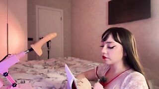 A hot Russian girl plays with a rubber dildo, imitating a nurse