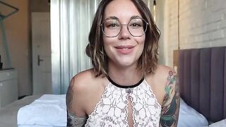 An inked woman shows how to spread legs and masturbate