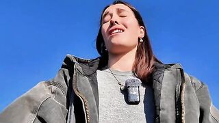 A hot brunette babe masturbates outdoors on a public beach, taking risks